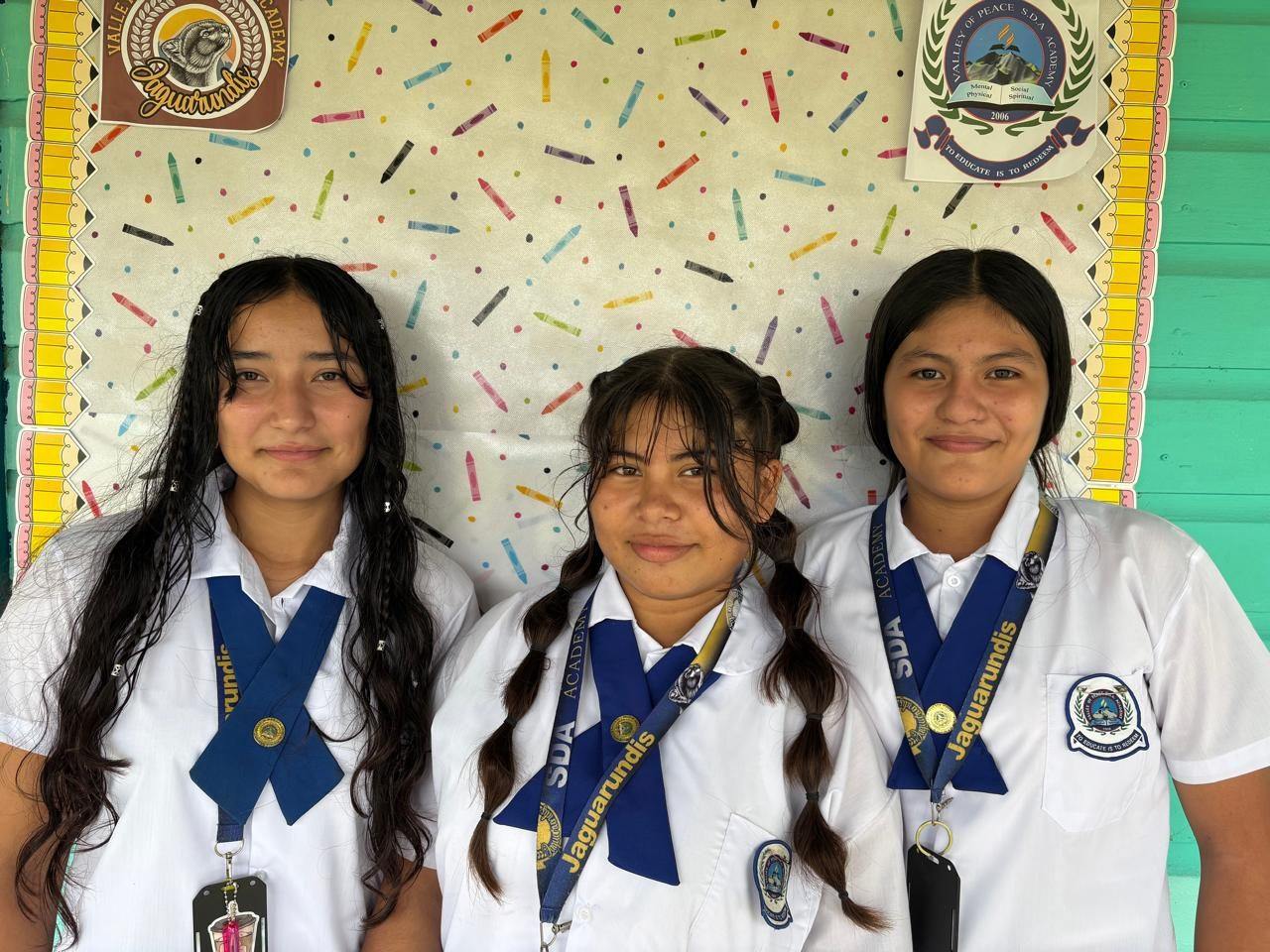 Three Valley of Peace students together on campus